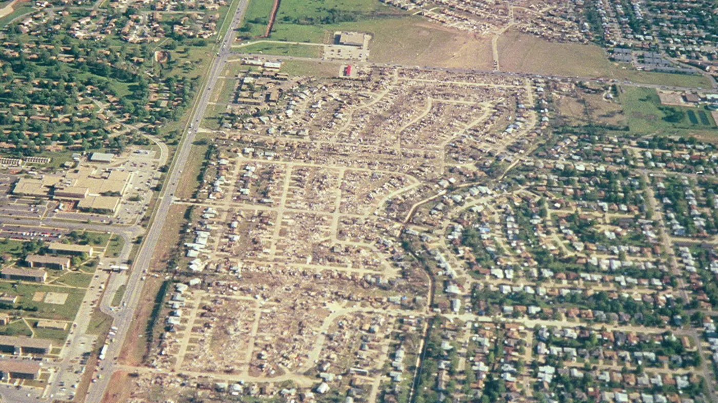 A destroyed residential street in Del City with houses reduced to rubble and debris.