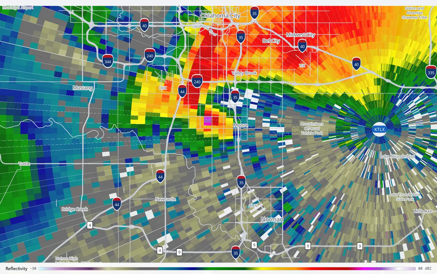 Coarse, blocky radar reflectivity over the Oklahoma City metro with a small magenta core beside Moore.