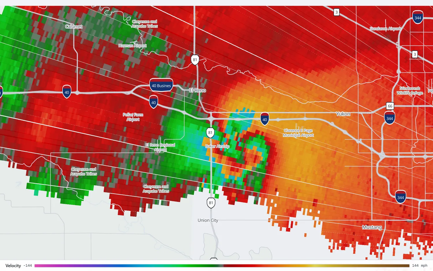 Radar velocity over El Reno showing a very large area of opposing inbound and outbound motion southeast of the town, with the most extreme gates in cyan.
