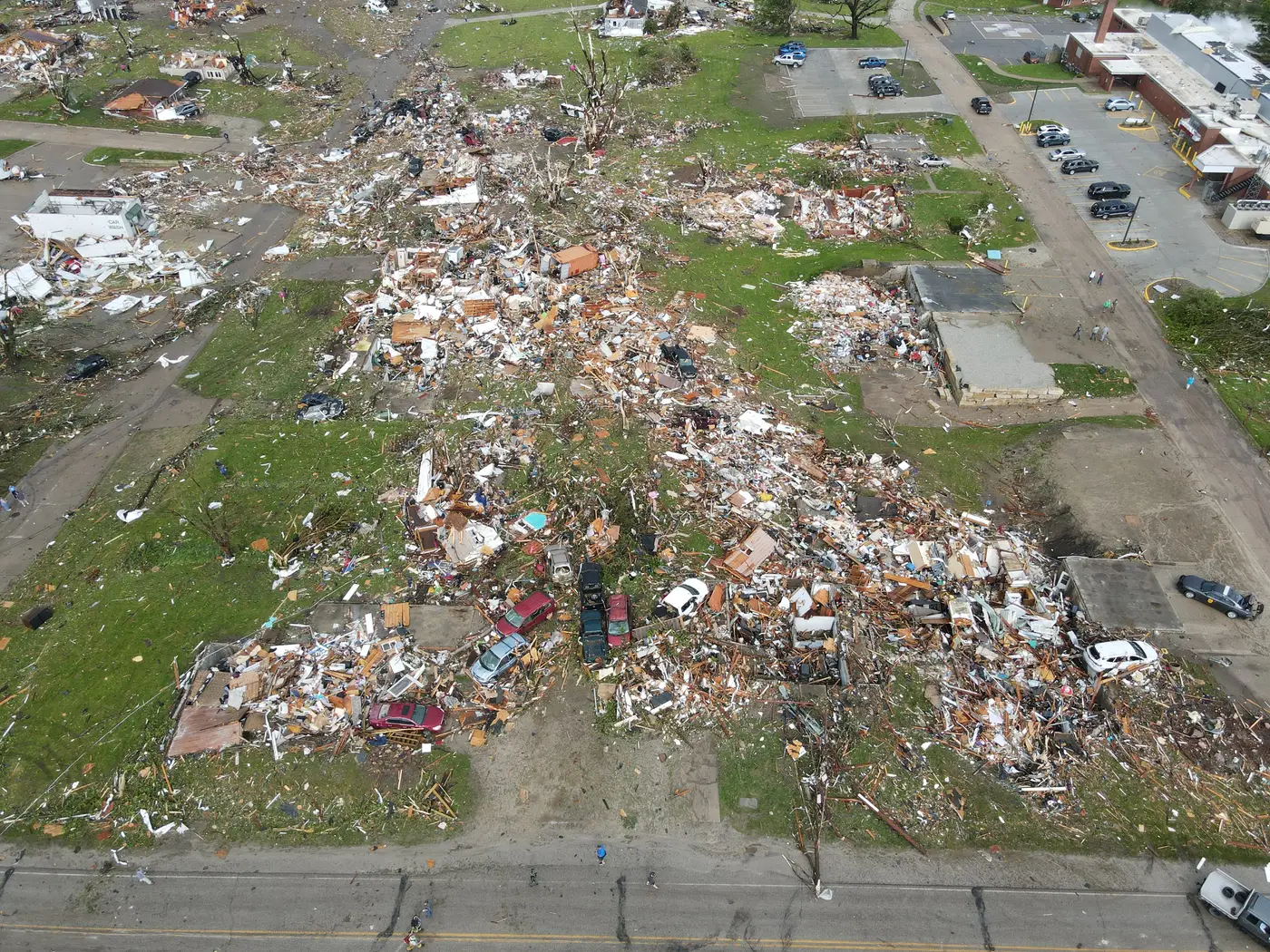 Drone view straight down a destroyed residential street in Greenfield: block after block of flattened homes, debris fields and crushed cars.