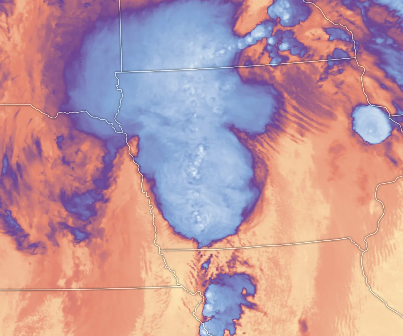 Satellite brightness-temperature image of a large storm complex over Iowa, with cold cloud tops in blue and pale overshooting tops embedded in the anvil.