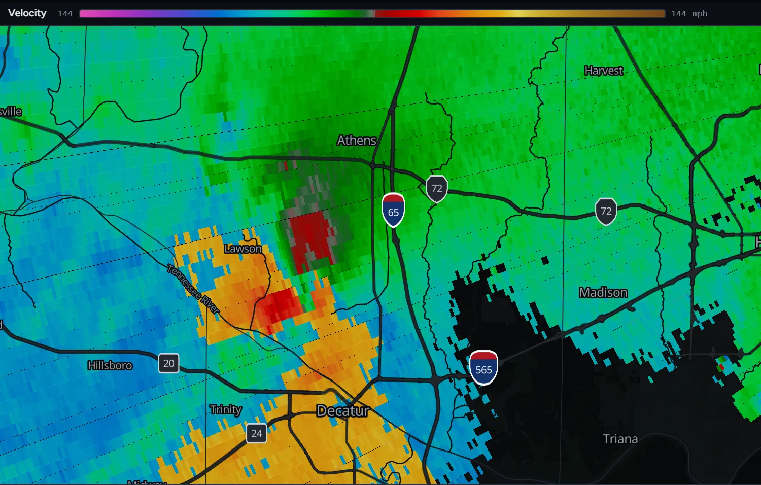 Radar velocity from KHTX over Limestone County, Alabama, showing a compact red outbound core beside green inbound flow between Lawson and Interstate 65, south of Athens.