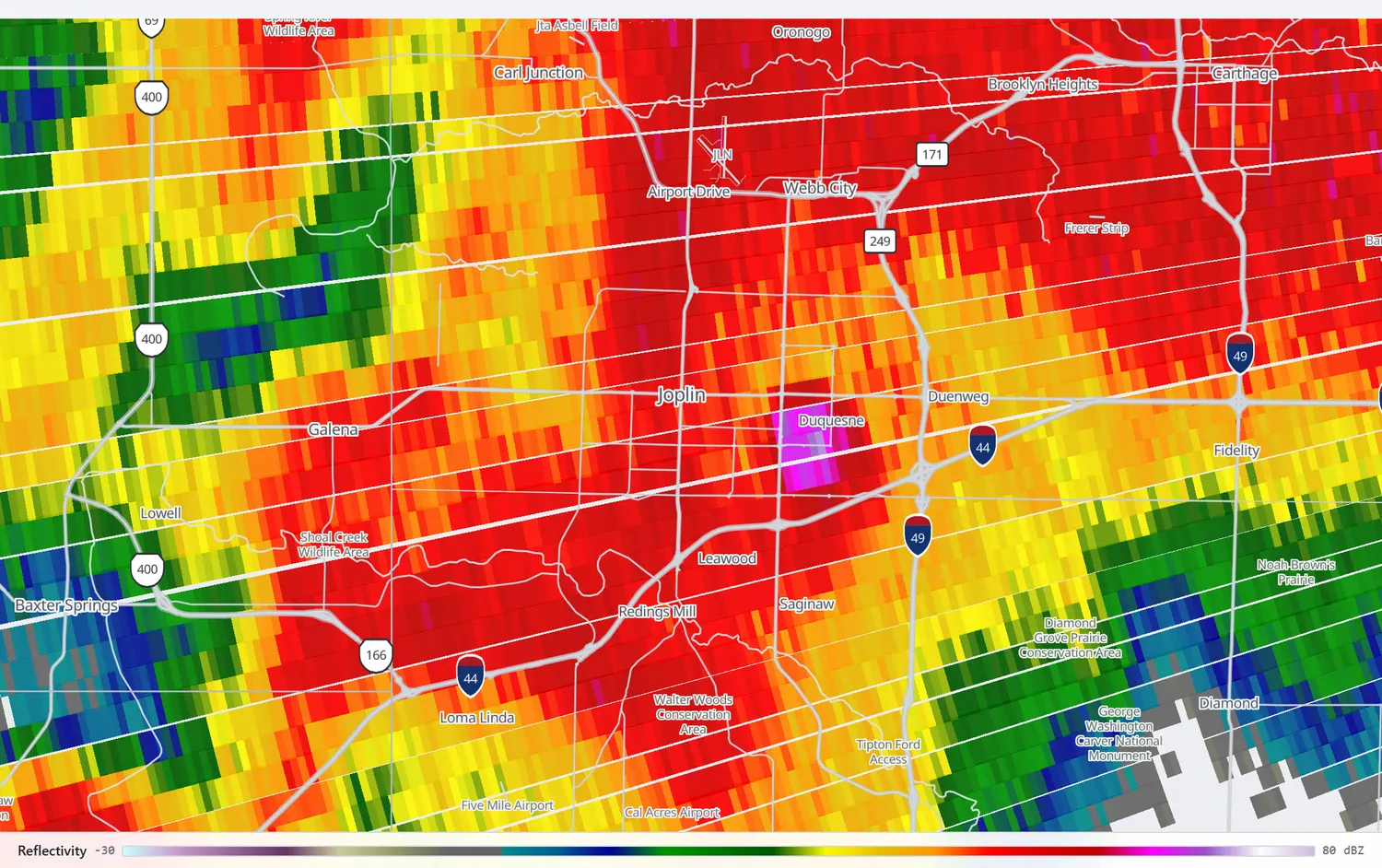 Radar reflectivity showing a hook echo wrapped around Joplin with a bright isolated core at its centre.