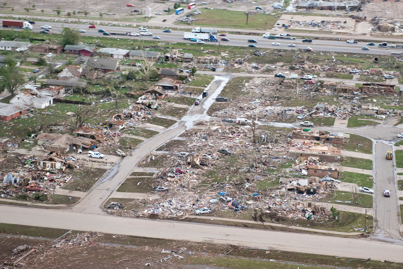 Aerial view of a levelled residential grid in Moore with Interstate 35 running along the top of the frame.