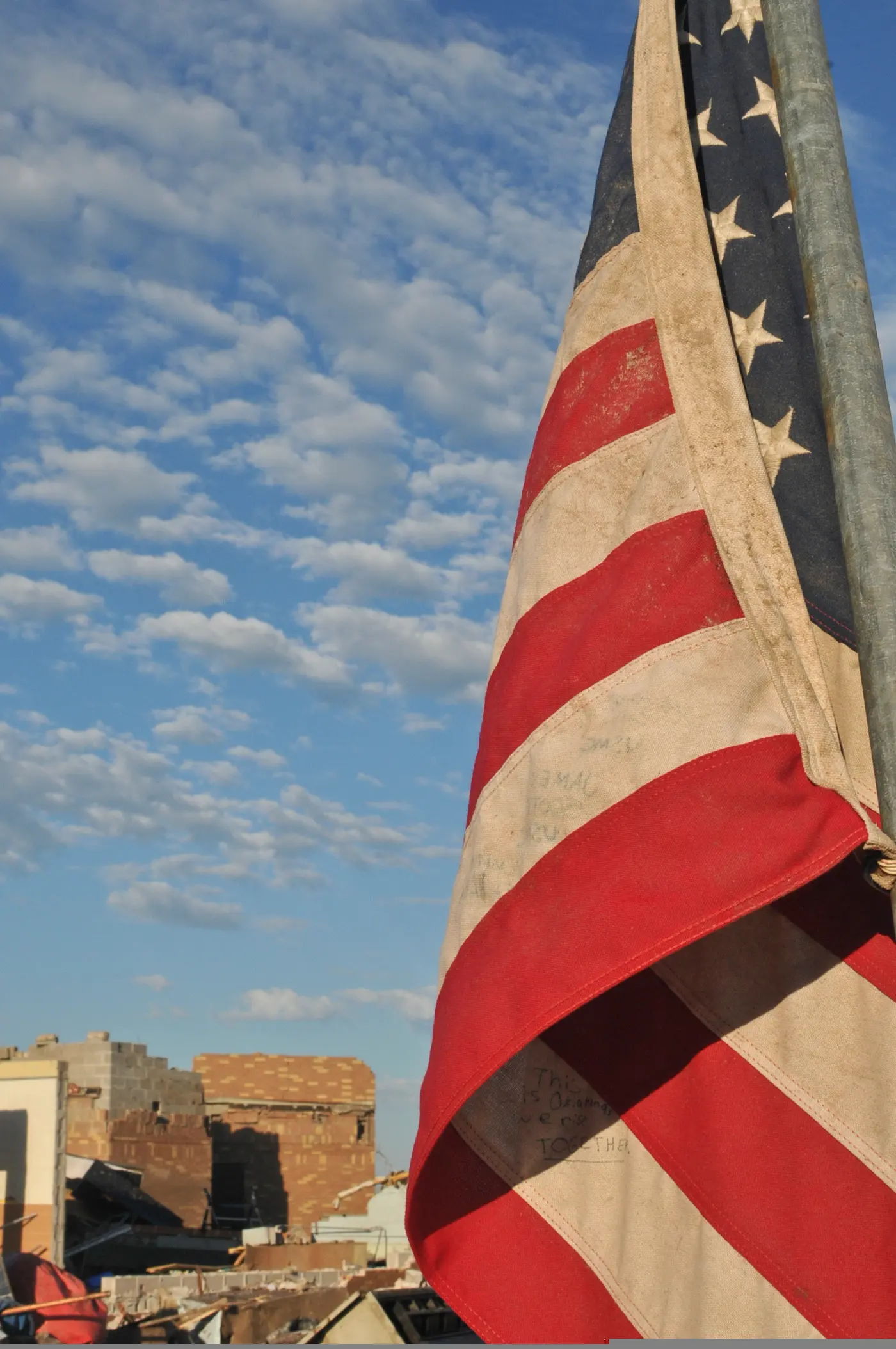 A United States flag standing amid the rubble of Briarwood Elementary School.