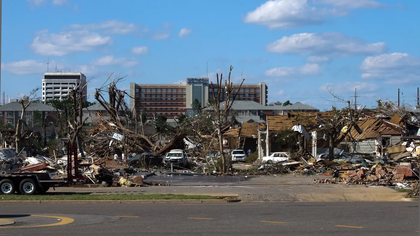 Destroyed buildings and stripped trees along McFarland Boulevard in Tuscaloosa the day after the tornado.